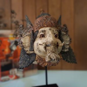Balinese Ganesha mask statue on wooden stand for yoga and meditation room decor